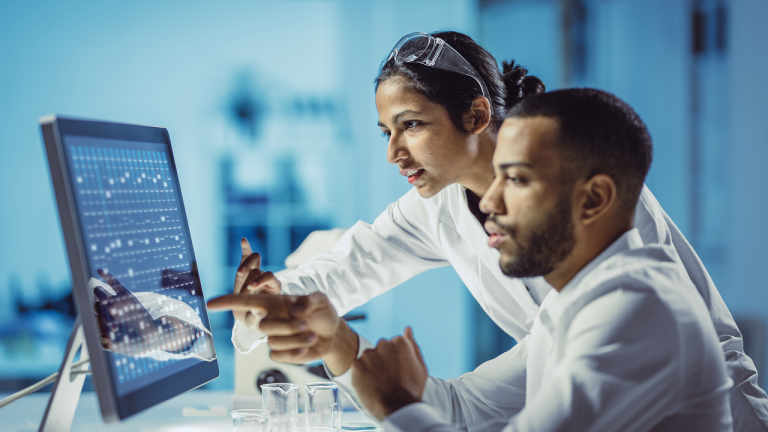 lab workers on a computer